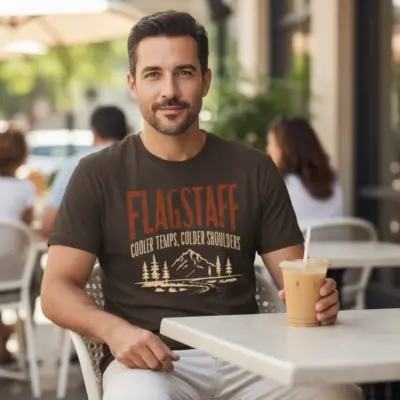 Espresso brown garment-dyed Comfort Colors t-shirt featuring Flagstaff Arizona souvenir destination city pride graphic worn by a man outdoors