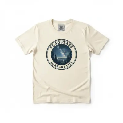 Ivory Comfort Colors garment-dyed t-shirt featuring Flagstaff dark sky constellation graphic and Stargazing City typography, front view on studio background