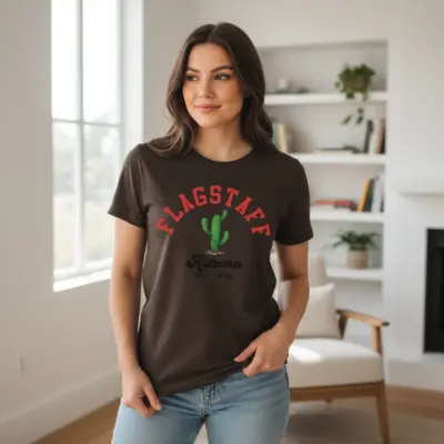 Woman wearing an espresso brown Comfort Colors t-shirt featuring Flagstaff Arizona Est. 1876 heritage typography print