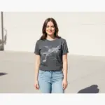 Woman wearing pepper-colored Comfort Colors t-shirt featuring Flagstaff downtown street grid and Route 66 map design in outdoor sunlight