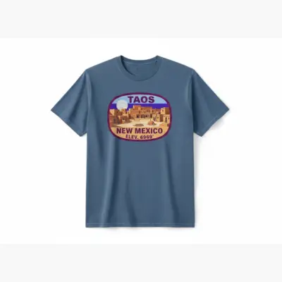 Blue Jean Comfort Colors t-shirt featuring Taos NM 6969 ft elevation and High Desert typography on front chest, studio frontal view