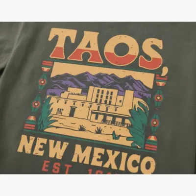 Moss green Comfort Colors t-shirt featuring Taos Est. 1615 New Mexico heritage typography design, close-up detail view