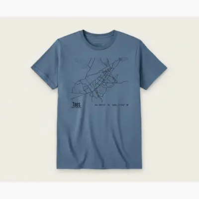 Blue Jean Comfort Colors t-shirt featuring a detailed street map illustration of Taos Plaza and Downtown Taos, New Mexico, displayed as a studio frontal product shot