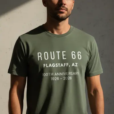 Man wearing moss green garment-dyed Comfort Colors t-shirt featuring retro Route 66 Flagstaff Arizona vintage hometown graphic
